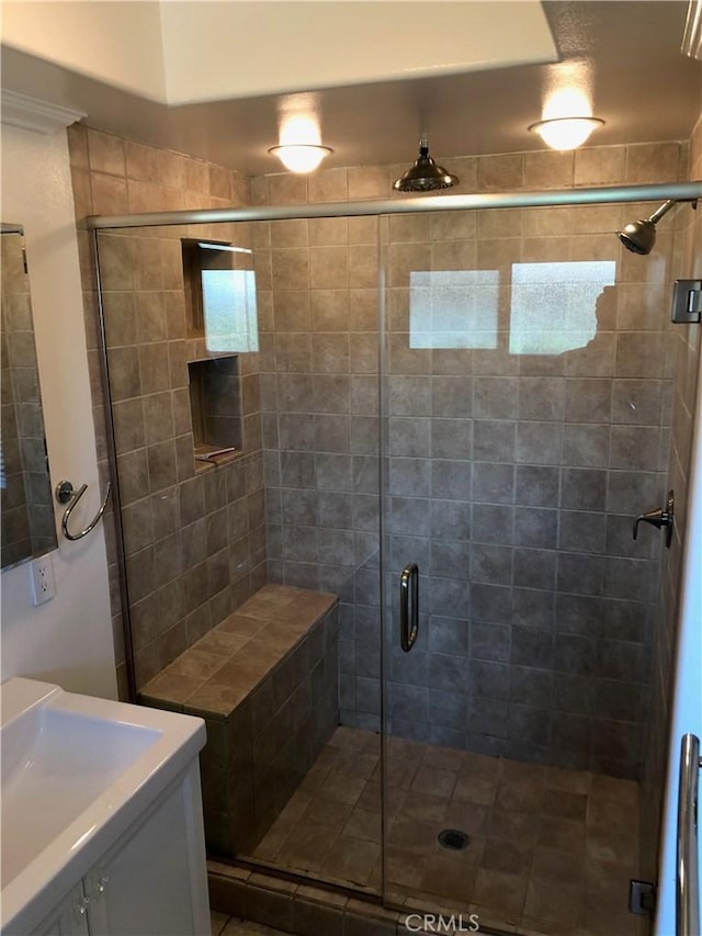 bathroom with vanity and a shower with shower door