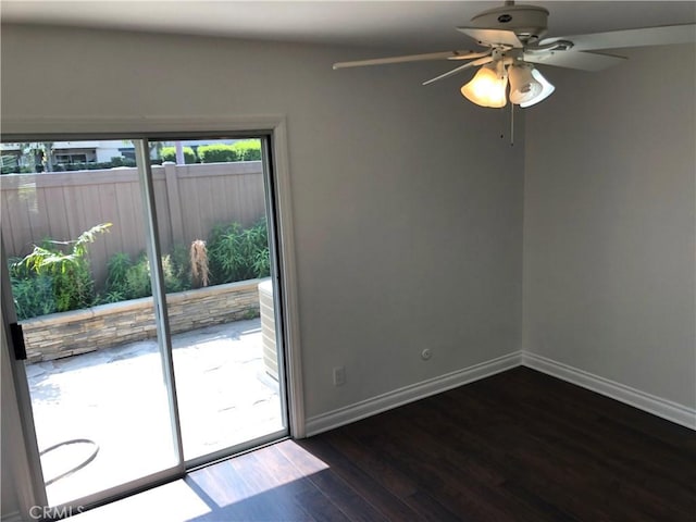 spare room featuring ceiling fan and dark wood-type flooring