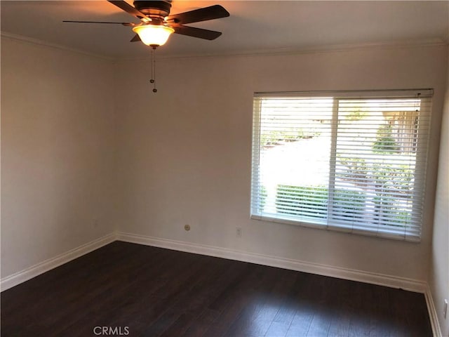 spare room with dark hardwood / wood-style floors, ceiling fan, and crown molding