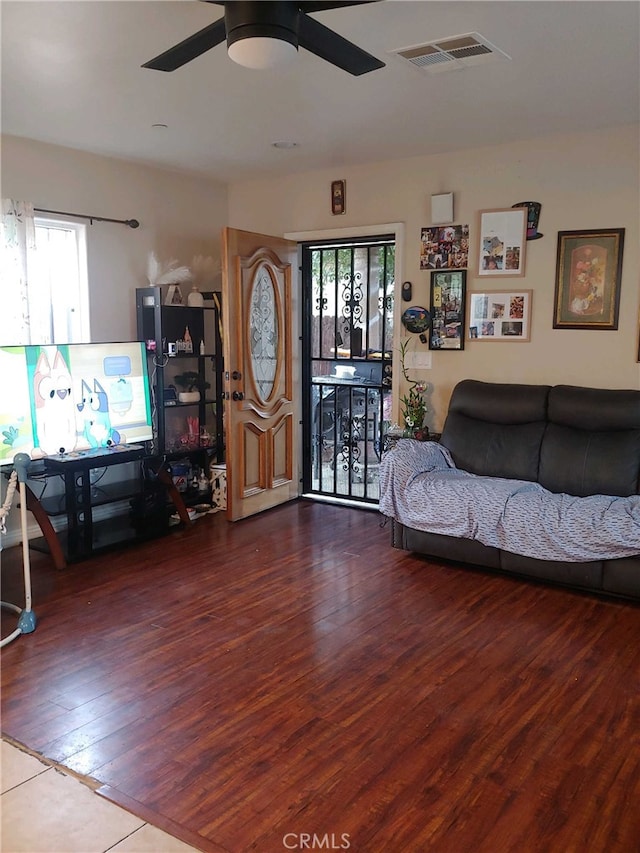 tiled living room featuring ceiling fan