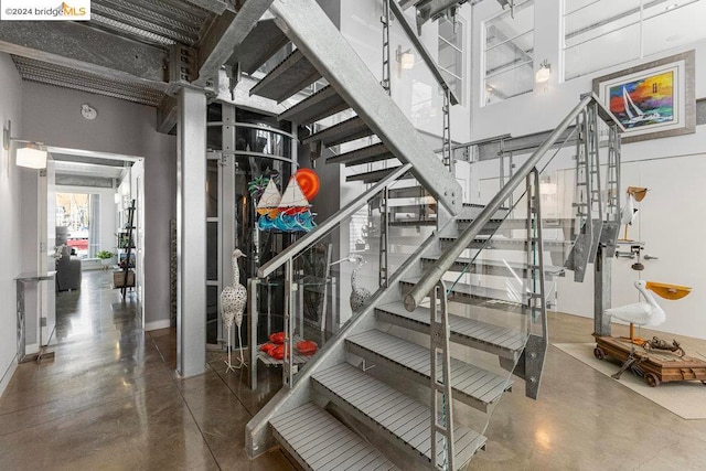 stairway featuring concrete flooring