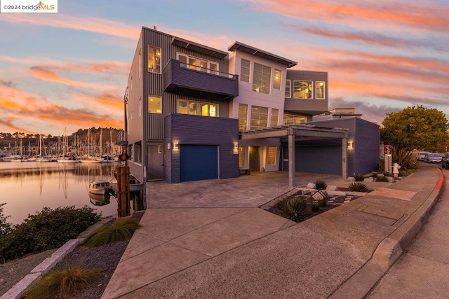 view of front of house with a balcony and a water view