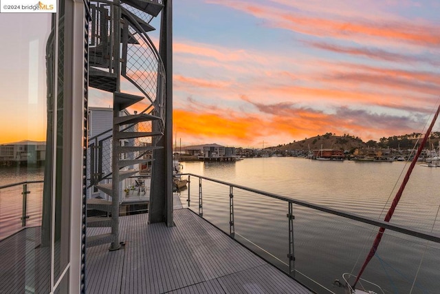 dock area featuring a water view and a balcony