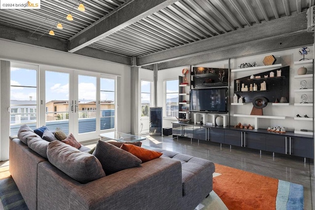 living room featuring dark tile patterned floors and beam ceiling