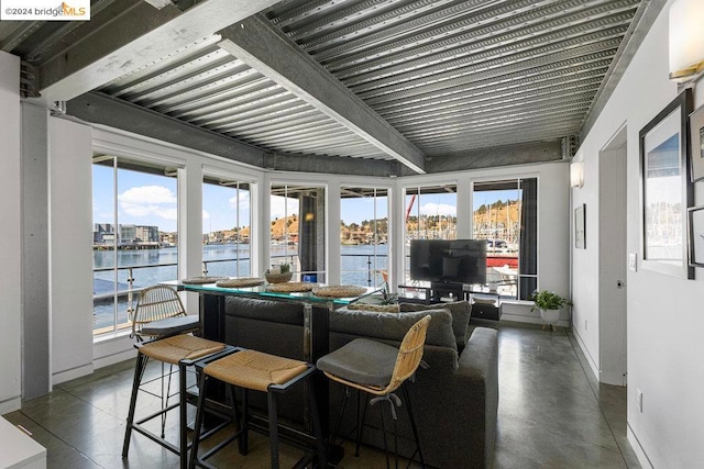 sunroom / solarium with a healthy amount of sunlight and beam ceiling