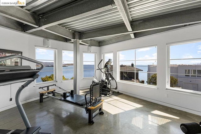 workout area with a water view and concrete floors