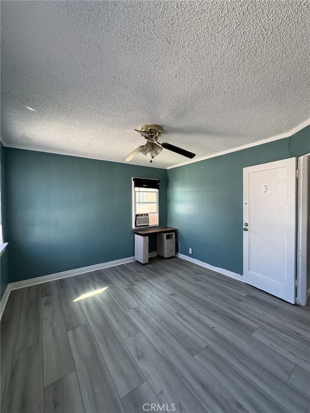 interior space with a textured ceiling, ceiling fan, ornamental molding, and hardwood / wood-style flooring