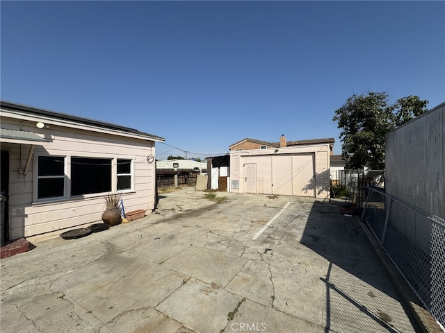 view of patio / terrace with an outbuilding