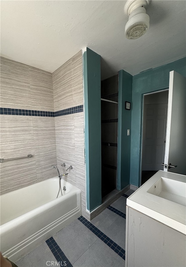 bathroom with tile patterned floors, vanity, and separate shower and tub