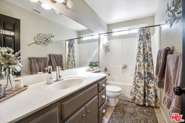 full bathroom featuring shower / tub combo with curtain, tile patterned floors, toilet, and vanity