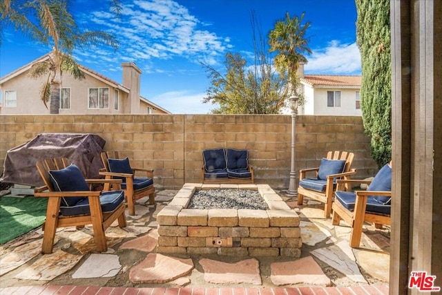 view of patio / terrace with area for grilling and a fire pit