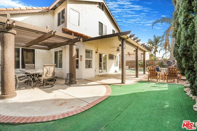 back of property with a pergola, a patio area, and ceiling fan