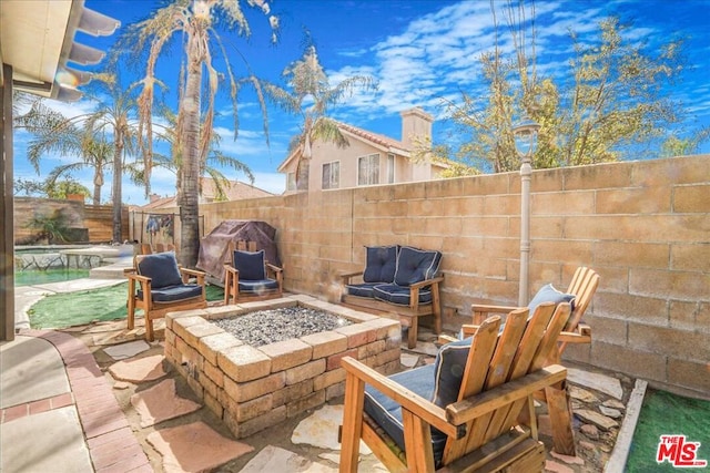 view of patio featuring an outdoor fire pit