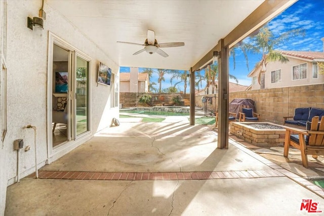 view of patio with a fire pit and ceiling fan