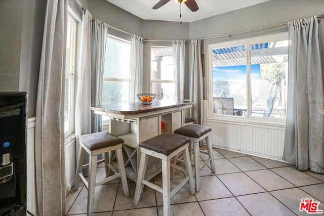 dining room with light tile patterned floors and ceiling fan