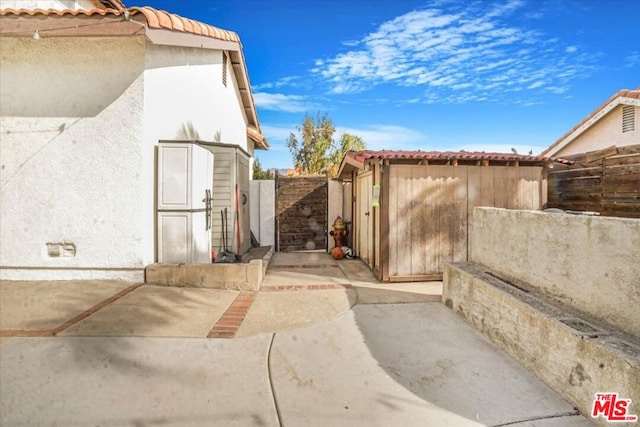 view of side of home with a patio