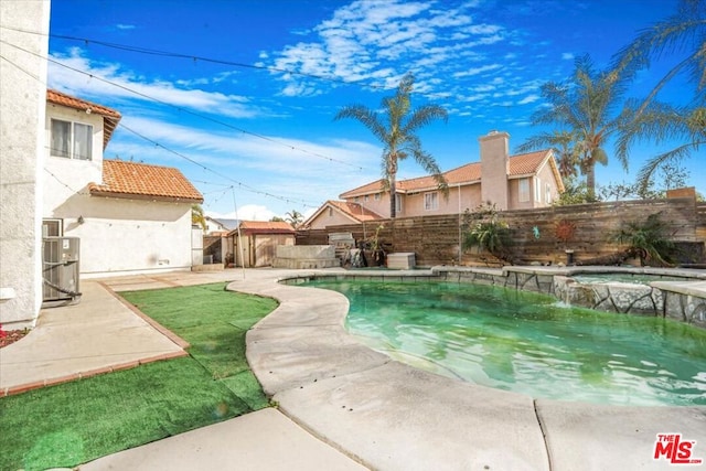 view of pool featuring an in ground hot tub, cooling unit, and a patio area