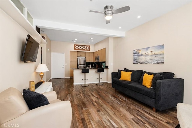 living room with ceiling fan, dark hardwood / wood-style flooring, and sink