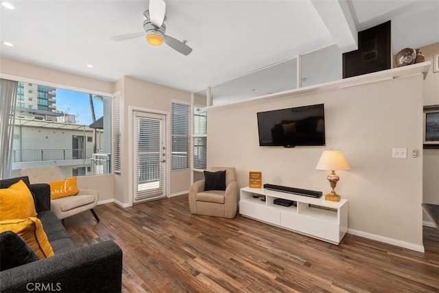 living room featuring ceiling fan and dark hardwood / wood-style floors