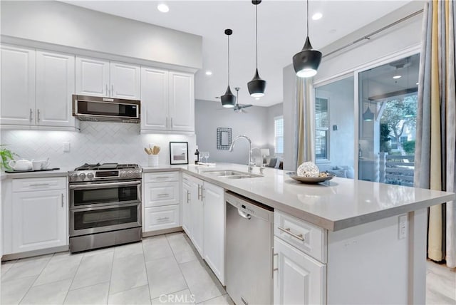 kitchen with a healthy amount of sunlight, white cabinetry, sink, and appliances with stainless steel finishes