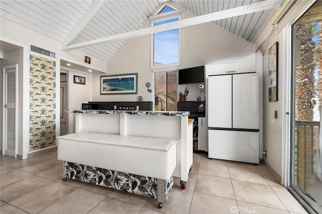 interior space featuring beamed ceiling, wood ceiling, and high vaulted ceiling