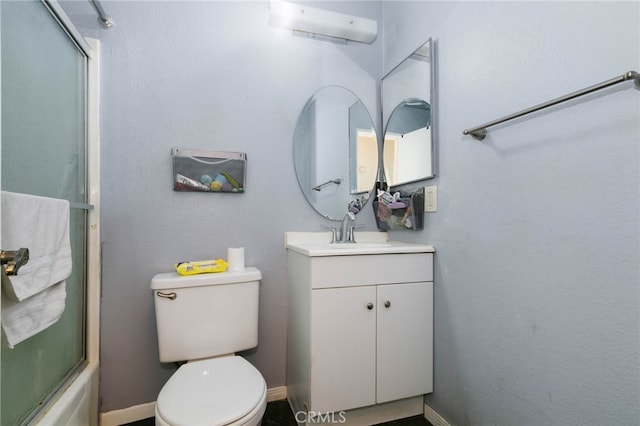 full bathroom featuring shower / bath combination with glass door, vanity, and toilet