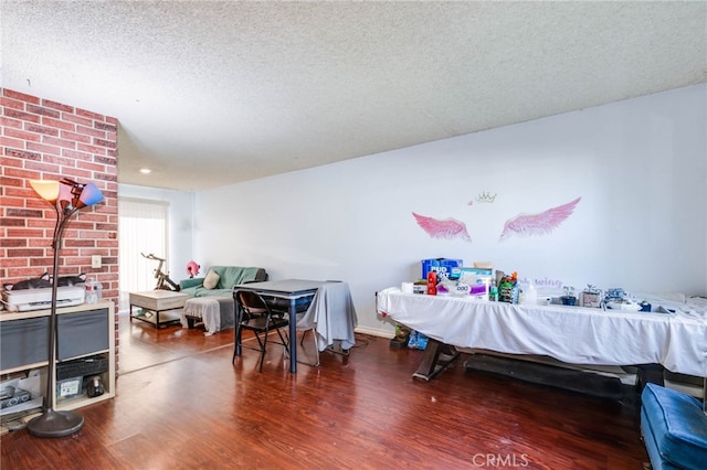 bedroom with a textured ceiling and dark hardwood / wood-style floors