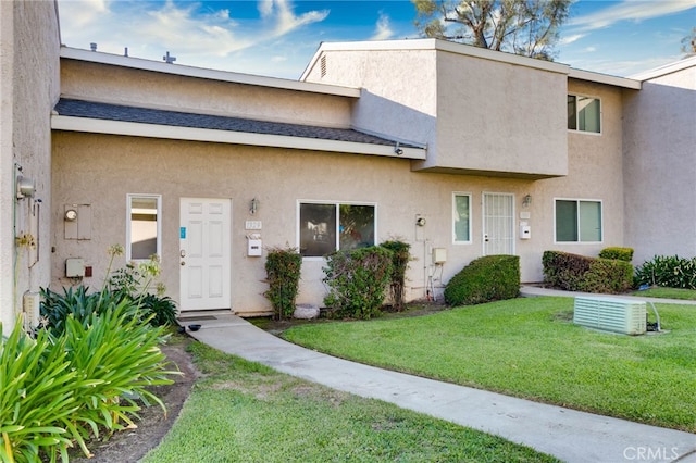 view of property featuring a front lawn