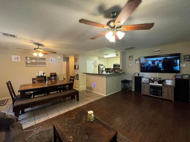 living room featuring ceiling fan and hardwood / wood-style floors