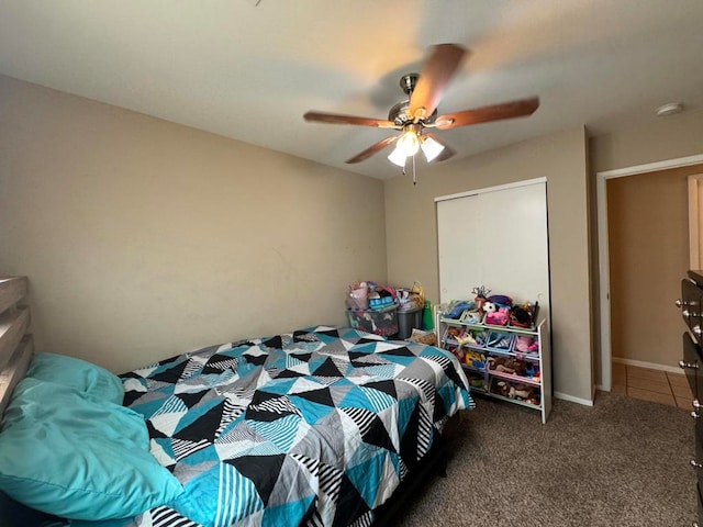 bedroom featuring ceiling fan and dark carpet