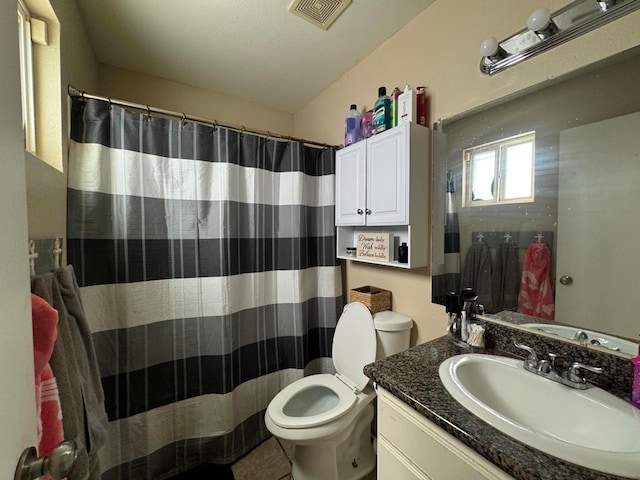 bathroom featuring vanity, tile patterned flooring, and toilet