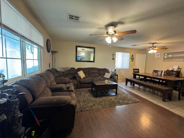 living room with light hardwood / wood-style floors and ceiling fan