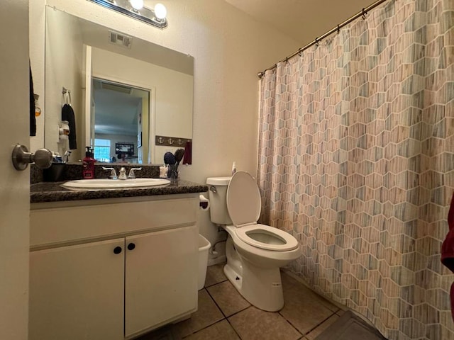 bathroom with a shower with shower curtain, vanity, toilet, and tile patterned floors