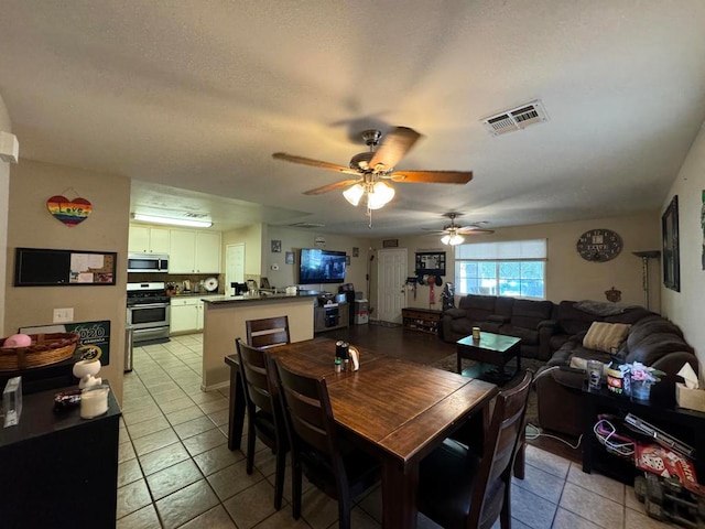 tiled dining space featuring ceiling fan