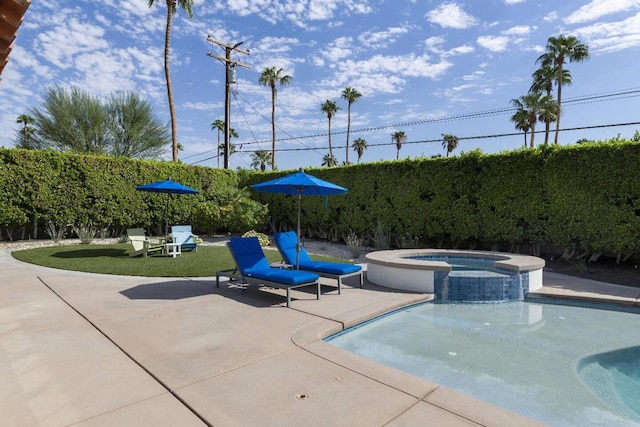 view of swimming pool featuring a patio and an in ground hot tub