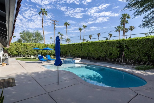 view of pool featuring an in ground hot tub and a patio area