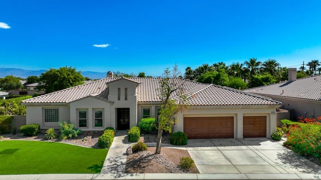 mediterranean / spanish house featuring a garage