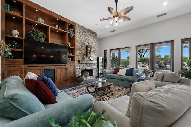 living room with a fireplace and ceiling fan