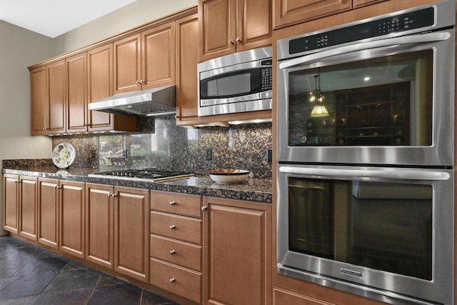 kitchen featuring appliances with stainless steel finishes and tasteful backsplash