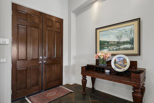 foyer with dark tile patterned flooring