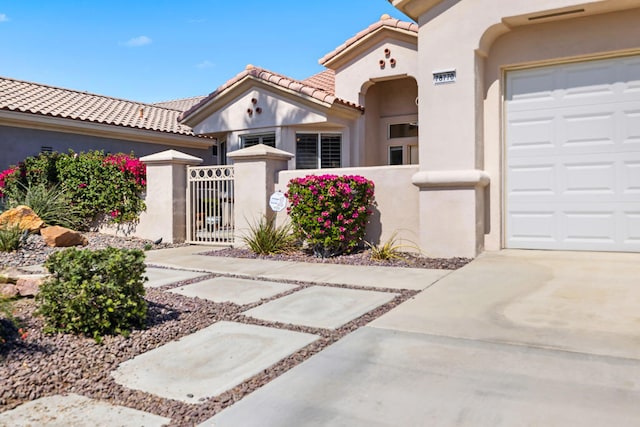 mediterranean / spanish-style house with a garage