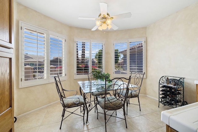 tiled dining area with ceiling fan