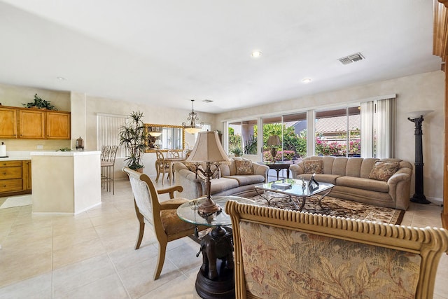 living room featuring light tile patterned flooring and a chandelier