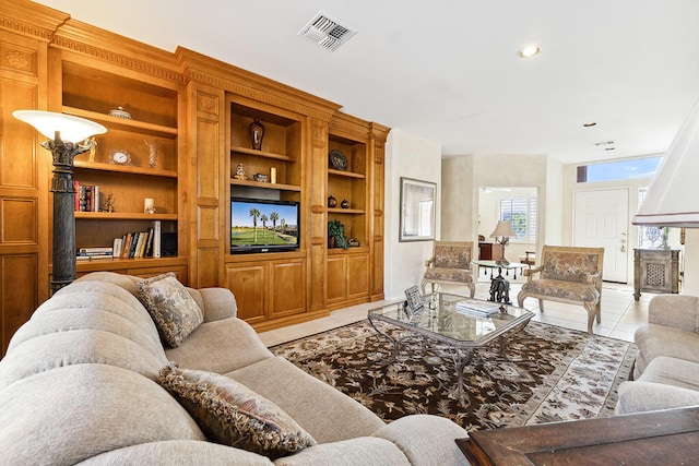 living room featuring light tile patterned floors and built in features