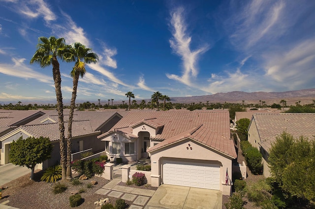 view of front facade with a mountain view and a garage