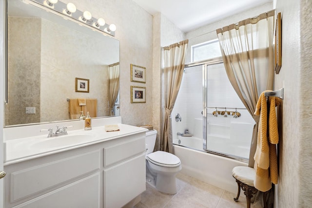 full bathroom featuring tile patterned flooring, vanity, toilet, and shower / bath combination with glass door