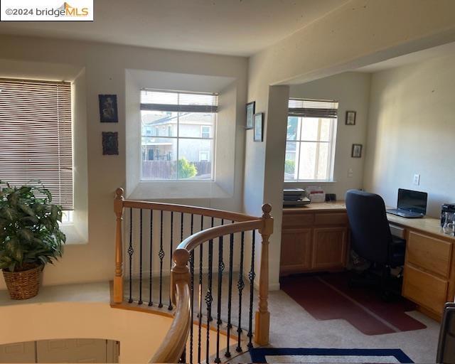 carpeted office with built in desk