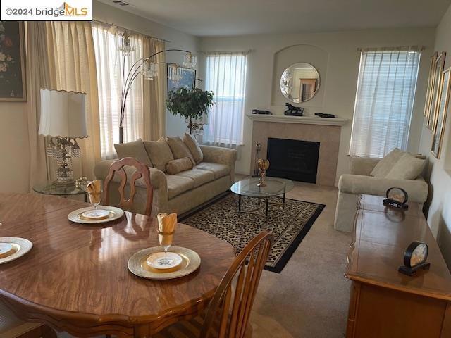 carpeted living room with a fireplace