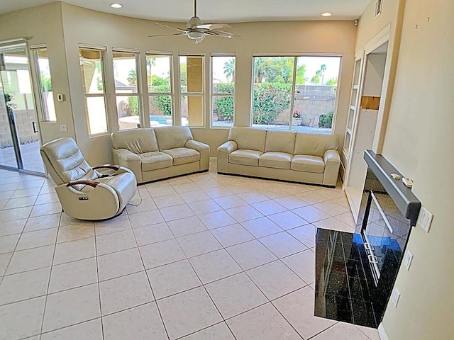 unfurnished living room featuring ceiling fan and light tile patterned floors