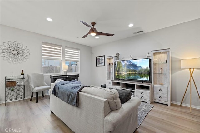 living room featuring ceiling fan and light wood-type flooring